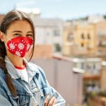One young female looking at camera and wearing a face mask