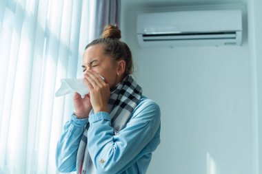 depositphotos_492569200-stock-photo-sneezing-woman-caught-cold-air